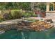 Inviting pool and spa area surrounded by rock features, lush greenery, and a relaxing ambiance at 32543 Hawks Lake Ln, Sorrento, FL 32776