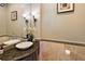 Stylish powder room with vessel sink and elegant lighting fixtures at 32543 Hawks Lake Ln, Sorrento, FL 32776