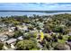 Aerial view of a charming home nestled in a lush, green neighborhood near a body of water at 3430 Laurel Dr, Mount Dora, FL 32757