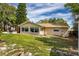 Spacious backyard with a patio area, hot tub, and well-maintained lawn at 3430 Laurel Dr, Mount Dora, FL 32757