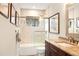 Modern bathroom with shower/tub combo, granite vanity, and a window for natural light at 3430 Laurel Dr, Mount Dora, FL 32757