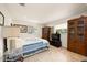Bedroom with furniture, large bed, hardwood floors, windows with coverings, and a modern lamp at 3430 Laurel Dr, Mount Dora, FL 32757
