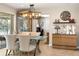 A dining area features a table with a glass top, seating for four, and a modern light fixture at 3430 Laurel Dr, Mount Dora, FL 32757