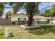 Charming home featuring mature trees, brick accents and manicured landscaping at 3430 Laurel Dr, Mount Dora, FL 32757