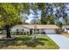 Charming home with a well-manicured lawn, brick accents and mature trees at 3430 Laurel Dr, Mount Dora, FL 32757