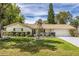 Charming single-story home with brick facade, well-manicured lawn, and fenced yard at 3430 Laurel Dr, Mount Dora, FL 32757