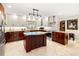 Spacious kitchen features stainless appliances, granite countertops, white cabinets, and a center island at 3430 Laurel Dr, Mount Dora, FL 32757