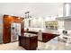 Bright kitchen with stainless steel appliances, granite countertops, an island, and modern light fixtures at 3430 Laurel Dr, Mount Dora, FL 32757