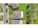 Drone shot of house featuring yard with patio, surrounded by green space, and mature trees at 3441 Landing Vw, Tavares, FL 32778