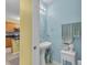 A half bath with a pedestal sink, stylish decor, and tile floors at 3441 Landing Vw, Tavares, FL 32778