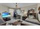 Bedroom with mountain art, striped bedding, a wood nightstand, and neutral walls at 3441 Landing Vw, Tavares, FL 32778