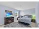 Cozy bedroom with a decorative TV stand featuring a fireplace and a ceiling fan at 3441 Landing Vw, Tavares, FL 32778