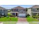 Charming two-story home with a brick driveway, well-manicured lawn and mature landscaping at 3441 Landing Vw, Tavares, FL 32778