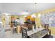 Modern kitchen open to dining area, featuring stainless steel appliances and granite countertops at 3441 Landing Vw, Tavares, FL 32778