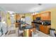 Spacious kitchen with stainless steel appliances, granite countertops, and breakfast bar seating at 3441 Landing Vw, Tavares, FL 32778
