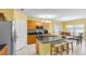 Open kitchen with stainless steel appliances, granite countertops, and an island with seating at 3441 Landing Vw, Tavares, FL 32778