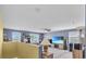 Living area features a TV, ceiling fan, and windows with natural light at 3441 Landing Vw, Tavares, FL 32778