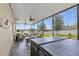 A screened-in patio with outdoor seating, a hot tub, and views of the lake at 3441 Landing Vw, Tavares, FL 32778