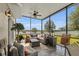 Screened-in patio featuring comfortable seating, a ceiling fan, and views of the backyard at 3441 Landing Vw, Tavares, FL 32778