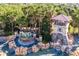 Beautiful water feature at community entrance with stone accents and lush tropical landscaping at 3441 Landing Vw, Tavares, FL 32778