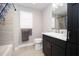 Well-lit bathroom featuring a sleek vanity with white countertop and dark wood cabinets and coordinated tile flooring at 3532 Thorne Path, Oxford, FL 34484