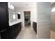 Bathroom featuring double marble vanity, dark cabinets, and tiled floors at 3532 Thorne Path, Oxford, FL 34484