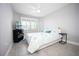 Neutral bedroom with a queen bed, tiled floors, and shuttered windows at 3532 Thorne Path, Oxford, FL 34484
