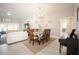 Bright dining room featuring tiled floors, modern light fixture, and access to the bathroom at 3532 Thorne Path, Oxford, FL 34484