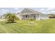 Home with a lush lawn and mature landscaping adding to its curb appeal at 3532 Thorne Path, Oxford, FL 34484