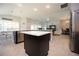 Open-concept kitchen with marble island, stainless steel appliances, and barstool seating at 3532 Thorne Path, Oxford, FL 34484