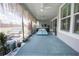 Spacious screened lanai with modern furniture, tropical plants, and views of the serene backyard; perfect for outdoor living at 3532 Thorne Path, Oxford, FL 34484