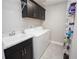 Practical laundry room with overhead cabinets, utility sink, and modern washer/dryer, maximizing functionality and storage at 3532 Thorne Path, Oxford, FL 34484