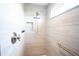 Modern tiled shower with a rain shower head, niche, and grab bar at 3532 Thorne Path, Oxford, FL 34484