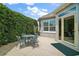 Back patio features an outdoor table and chairs with beautiful garden view at 3537 Cluster Ct, The Villages, FL 32163