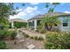 Charming backyard with lush landscaping and stone walkway leading to the house at 3537 Cluster Ct, The Villages, FL 32163