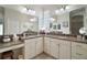 Well-lit bathroom featuring double sinks, granite countertops, and tiled floors at 3537 Cluster Ct, The Villages, FL 32163