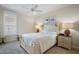 Cozy bedroom with a ceiling fan, window, and two bedside lamps at 3537 Cluster Ct, The Villages, FL 32163