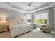 Bright primary bedroom with tray ceiling, white carpet, and large windows at 3537 Cluster Ct, The Villages, FL 32163