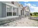 Close-up of the home's facade, featuring a stone planter and hardscape and gray shutters at 3537 Cluster Ct, The Villages, FL 32163
