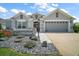 Well-maintained home with a two-car garage, beautiful landscaping, and a stone walkway at 3537 Cluster Ct, The Villages, FL 32163
