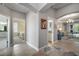 Hallway showing access to a bedroom, bathroom, and living room with neutral paint and tile flooring at 3537 Cluster Ct, The Villages, FL 32163