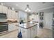 Well-appointed kitchen with granite counters, stainless steel appliances, and center island with breakfast bar at 3537 Cluster Ct, The Villages, FL 32163