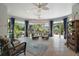 Bright living room featuring tile floors, ceiling fans, and large windows overlooking the garden at 3537 Cluster Ct, The Villages, FL 32163