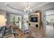 Bright and airy living room with a decorative media center and sliding glass doors at 3537 Cluster Ct, The Villages, FL 32163
