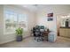 Bright home office featuring a large window, desk, and an ensuite bathroom at 3537 Cluster Ct, The Villages, FL 32163