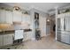 Kitchen area featuring a built-in desk with granite counters and stainless steel refrigerator at 3537 Cluster Ct, The Villages, FL 32163