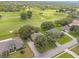 Aerial view showcasing homes, a golf course, and lush green landscape of the community at 36700 Oconee Ave, Eustis, FL 32736