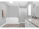 Bathroom featuring a soaking tub, walk-in shower, and vanity with granite counters at 36700 Oconee Ave, Eustis, FL 32736