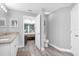 Bathroom features a granite vanity and a doorway into the bedroom at 36700 Oconee Ave, Eustis, FL 32736