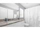 Clean bathroom featuring a granite vanity and a shower with a white curtain at 36700 Oconee Ave, Eustis, FL 32736